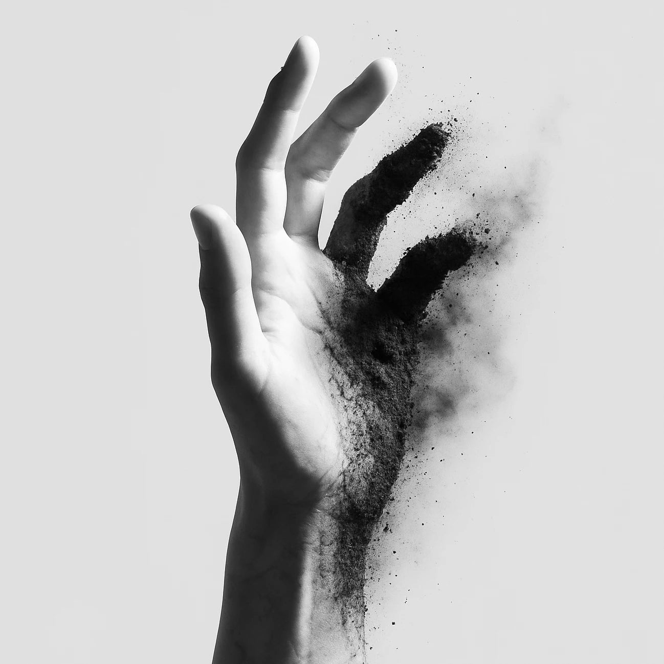 Hand with black powder on a light background